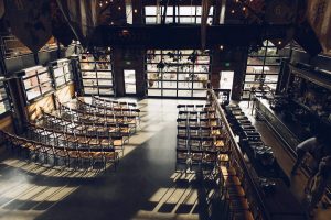 main floor of Twin Sister's brewing set up for a wedding with chairs and aisle