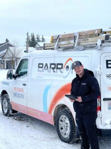 Barron Heating and Air Conditioning  tech and van in snow