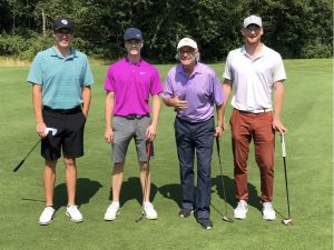 golfers standing in a row at the One Community One Family Golf Classic