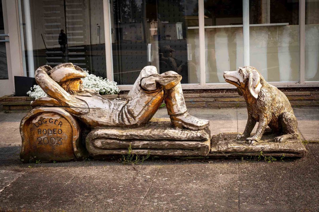 Sedro-Woolley carving of reclining cowboy and his dog.