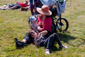 family sitting on grass at Budfest