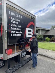 Barron tech standing behind their Barron truck