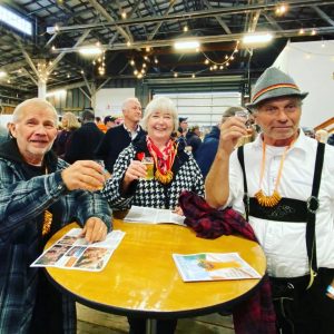 large group of people at a table drinking beer