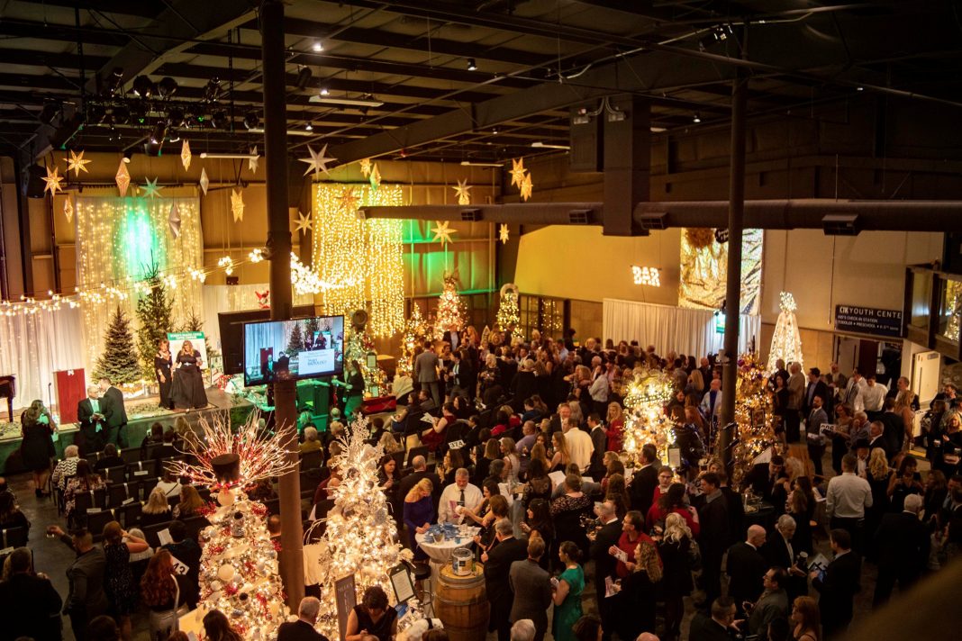 people indoors looking at decorated Christmas Trees at the The Skagit Regional Health Foundation's annual Festival of Trees