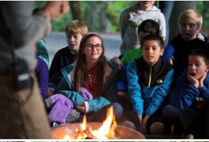 kids sitting around a campfire at North Cascade Mountain School