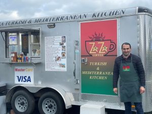 Leo Zaza next to his metal food truck in Anacortes