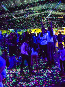 people skating under a black light at Skagit Skate's New Year's Eve Party