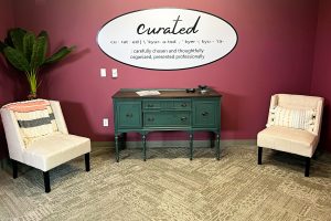 The Curated Home's front entrance with a couch and two chairs