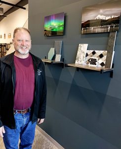 The Curated Home owner Bryan Ogle next to a wall of samples