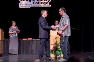 Joel Aparicio on stage receiving his award at Skagit Valley College