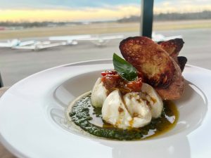  Burrata with Tomato Confit and Pesto Crostini. 