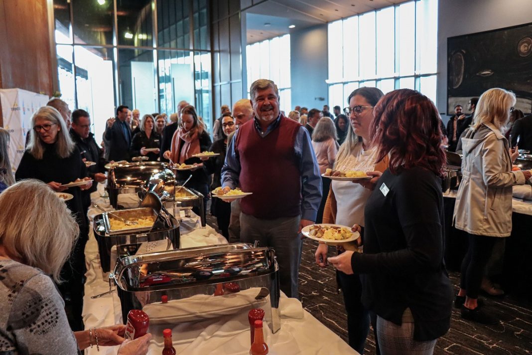 Large group of people at a buffet breakfasat