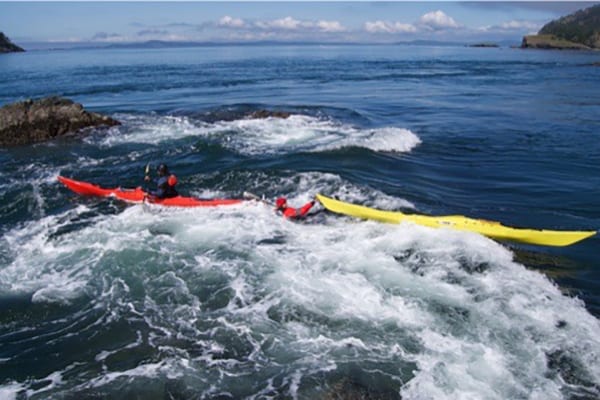 two kayaks in white water at Deception Pass