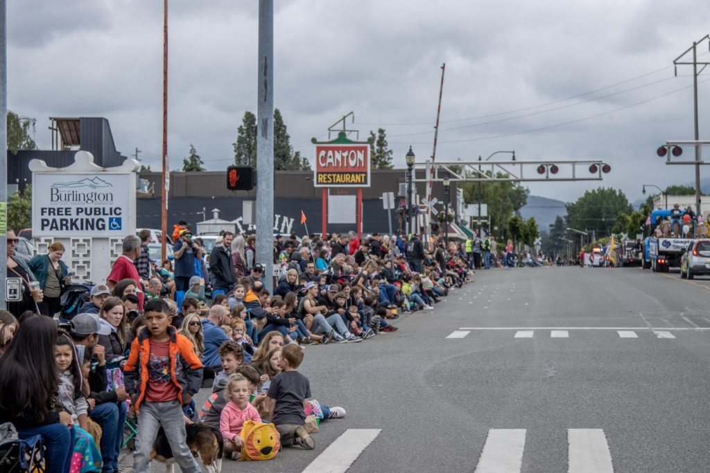 large crowds lining a street to watch a parade