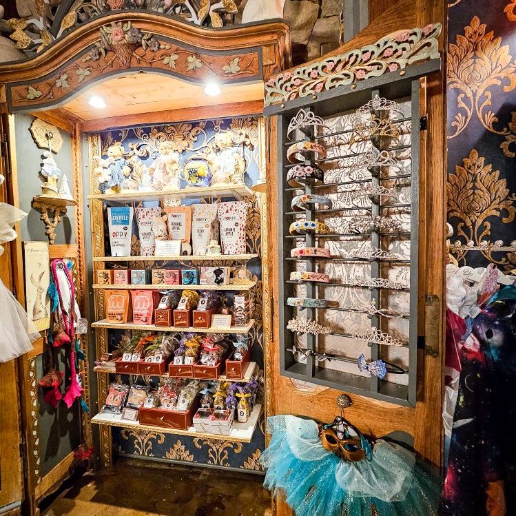 Gift shop in White Branches in Mount Vernon with a large cabinet holding many things including tiaras, sweets, masks and more
