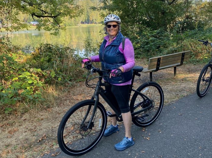 Olympia -E-bikes-Overview-Points-of-Interest-Lori-Barney a woman on her e-bike on a paved path