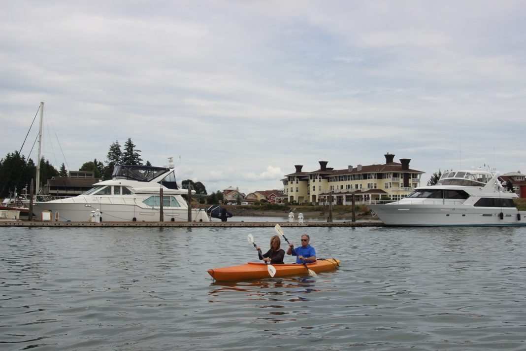 people in a two-person kayak at Port Ludlow Resort