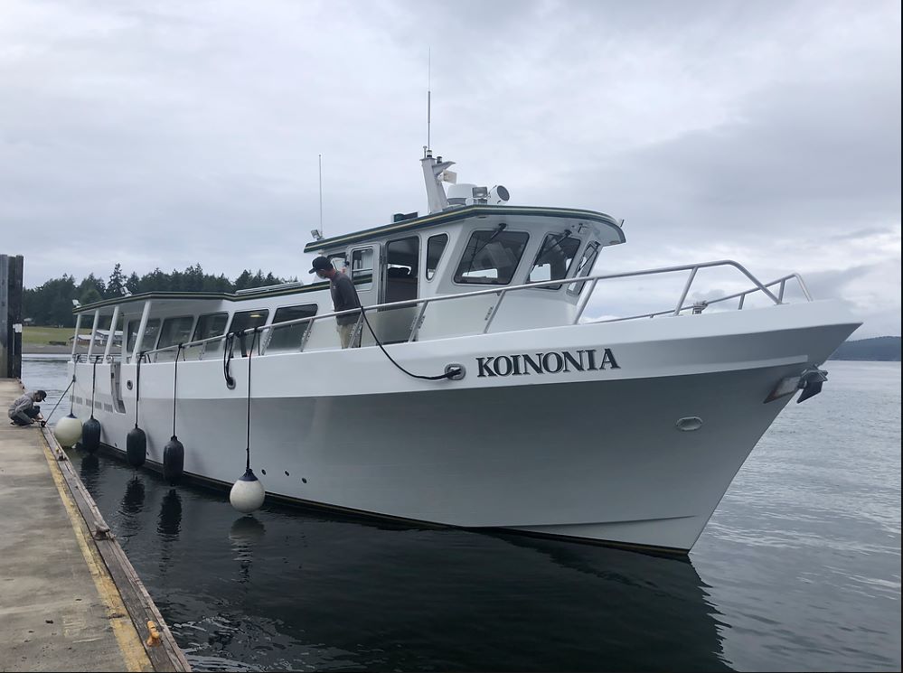 a boat on the Salish Sea next to a dock