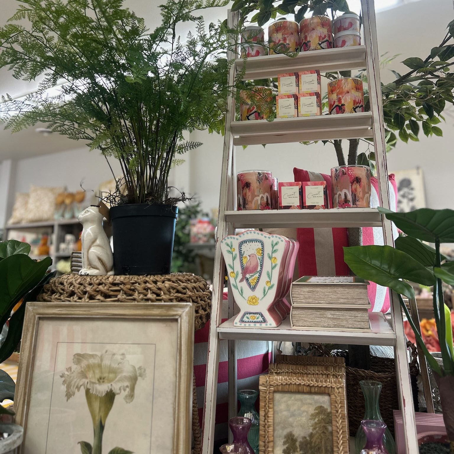 a table piled with home decor including wall art, vases, etc. 