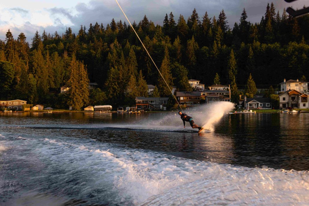 A wakeboarder having a blast behind a Whatcom Wake Sports boat on Bellingham's Lake Whatcom.